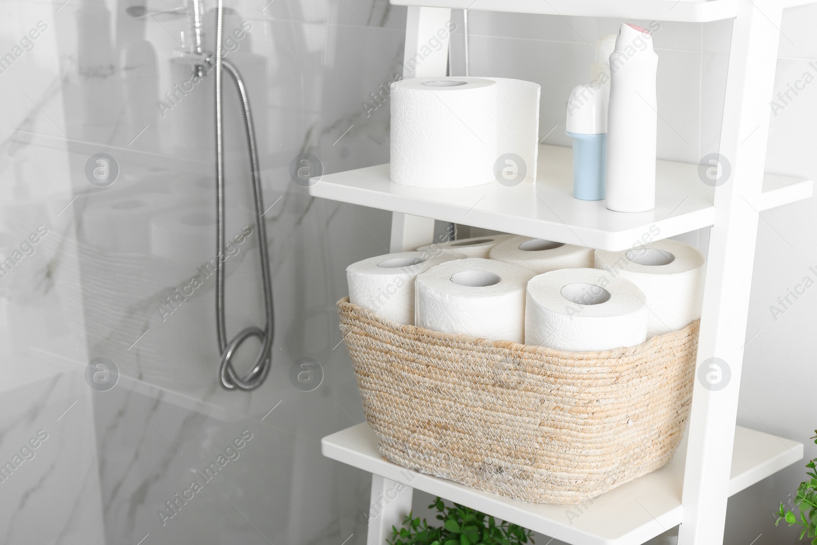 Photo of Toilet paper rolls on shelving unit in bathroom