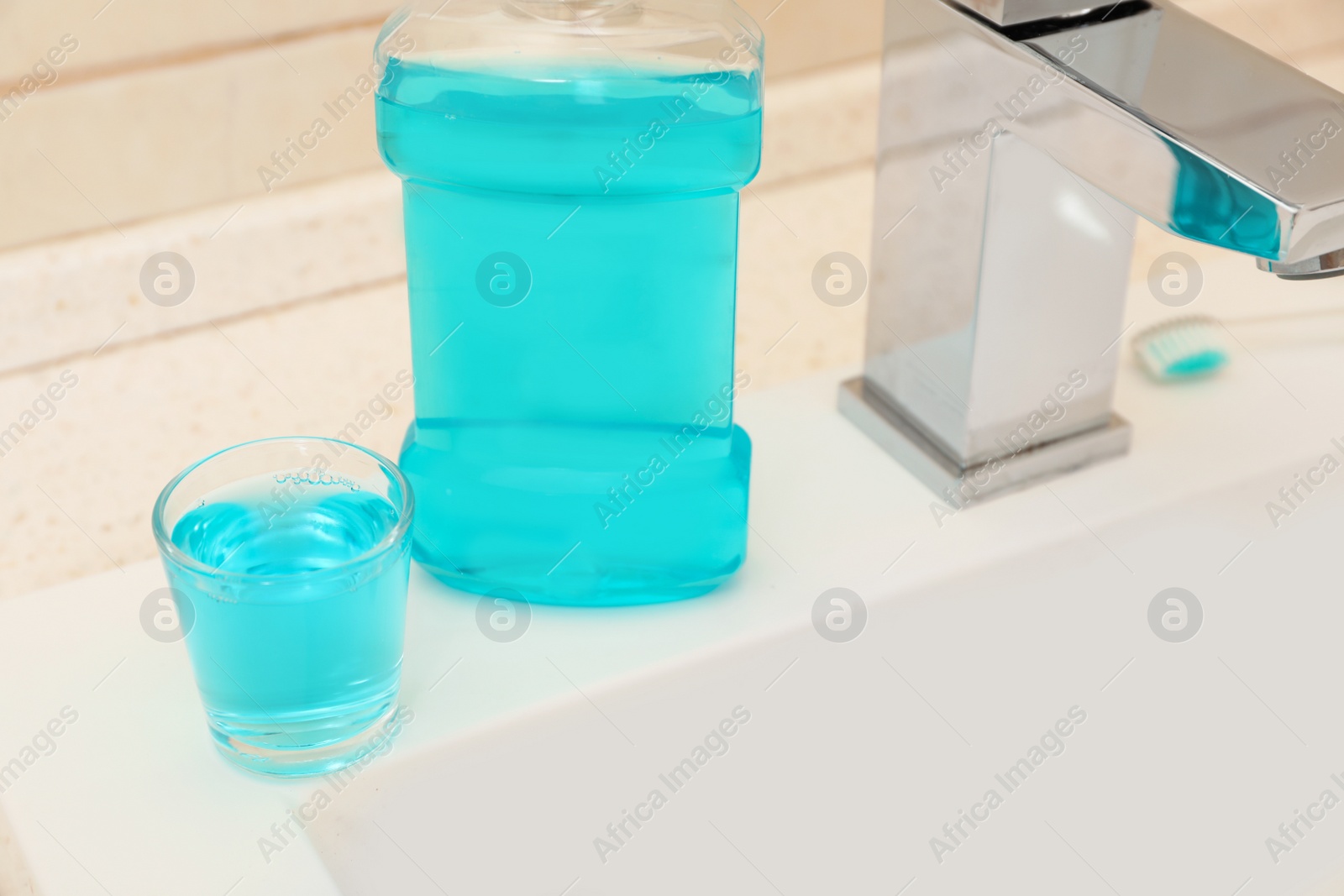 Photo of Mouthwash near tap on sink in bathroom. Teeth and oral care