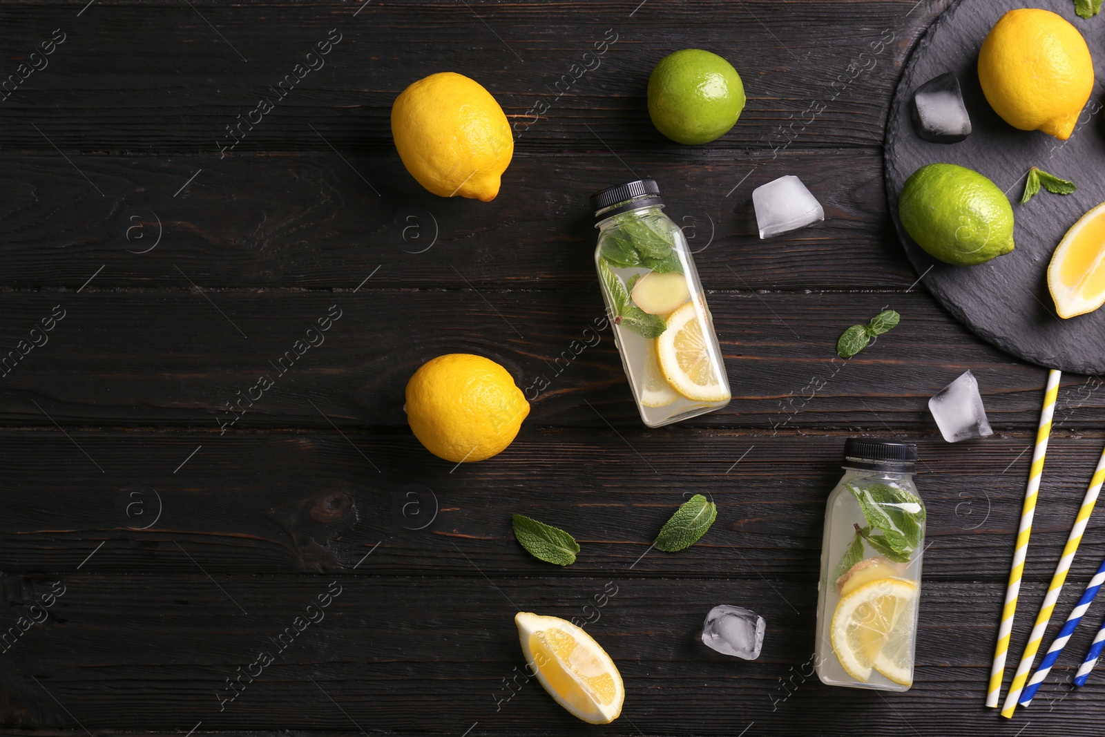 Photo of Flat lay composition with detox lemonade and ingredients on wooden background