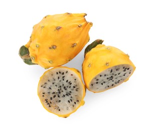 Photo of Delicious cut and whole yellow pitahaya fruits on white background, top view
