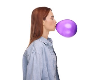 Woman inflating purple balloon on white background