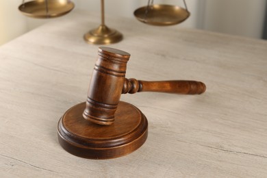 Photo of Law concept. Judge's mallet on light wooden table