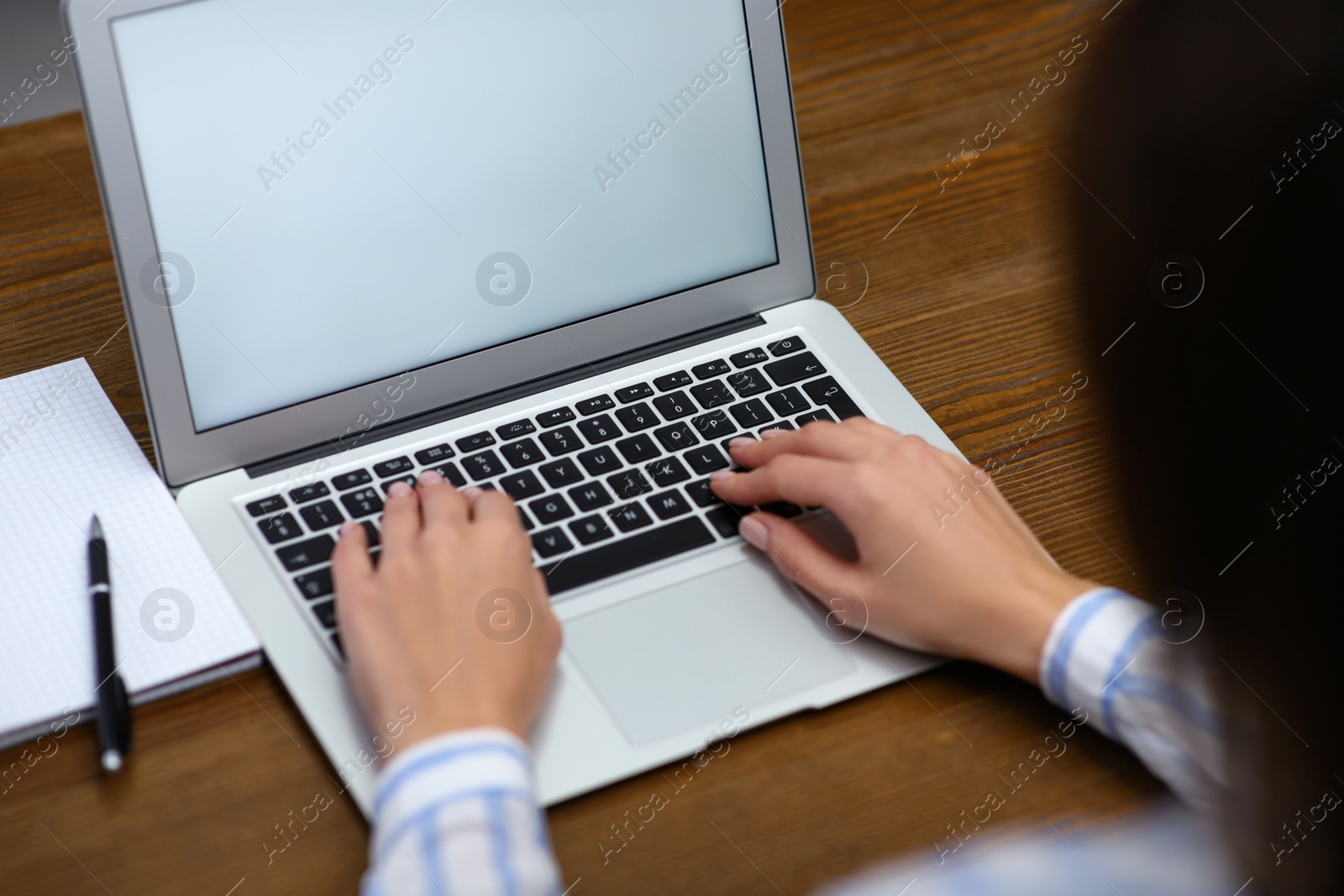 Photo of Woman working on modern laptop at table, closeup