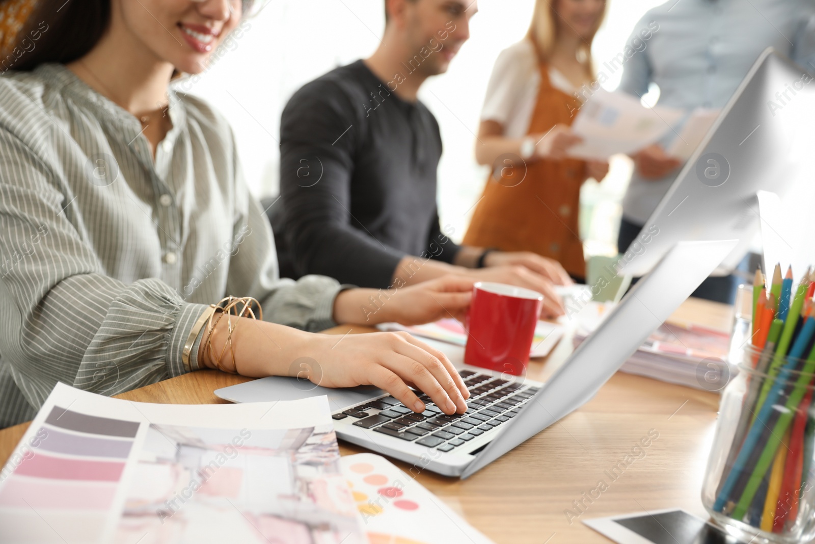 Photo of Team of professional designers working in office