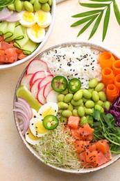 Photo of Delicious poke bowls with vegetables, fish and edamame beans on light table, flat lay