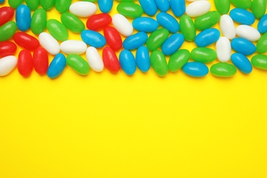 Photo of Flat lay composition with jelly beans on color background. Space for text