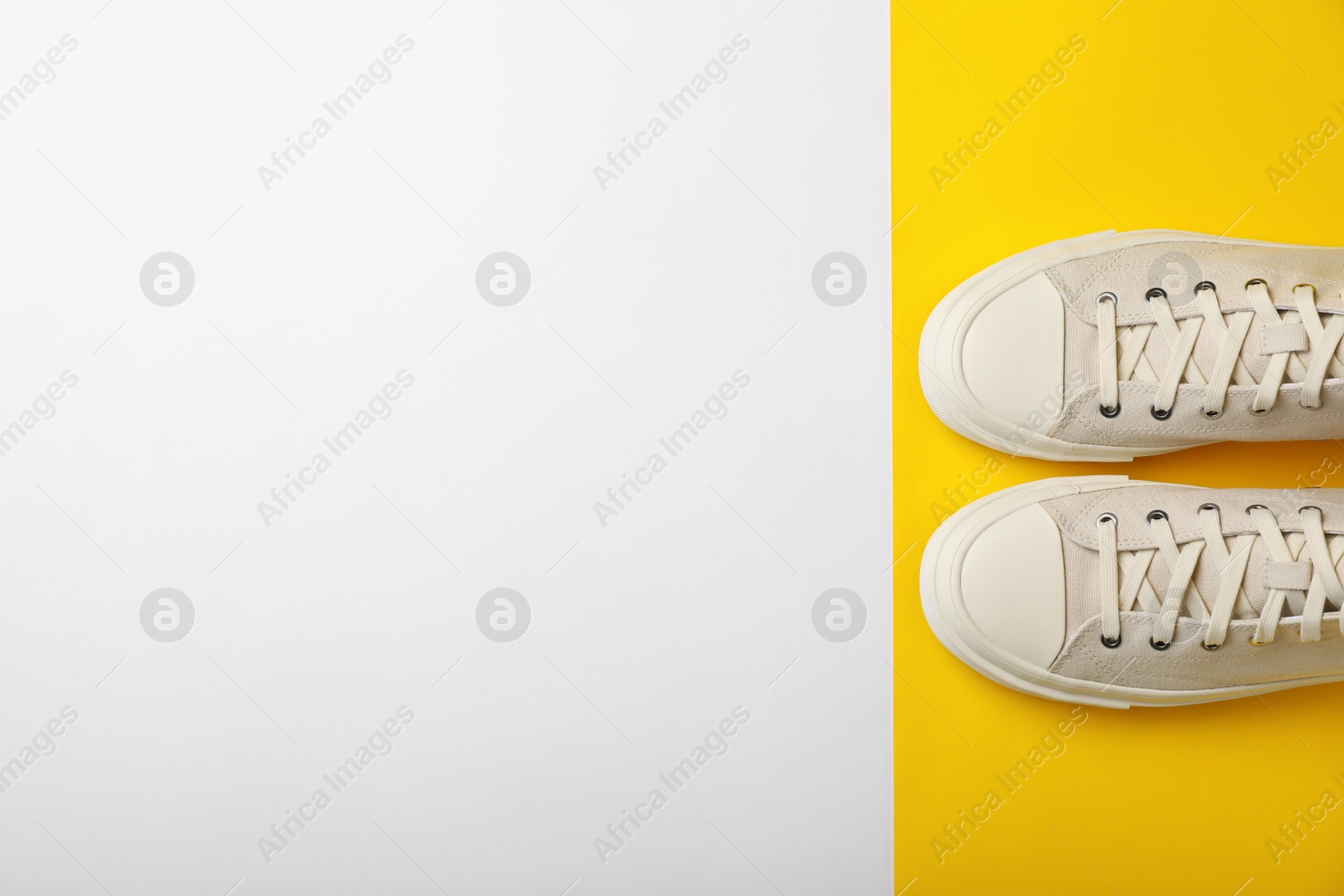 Photo of Pair of sneakers on color background, top view