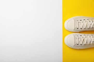 Photo of Pair of sneakers on color background, top view