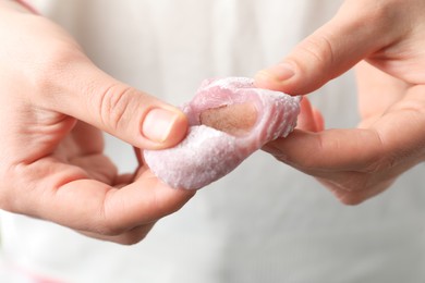 Woman with delicious mochi, closeup. Japanese cuisine