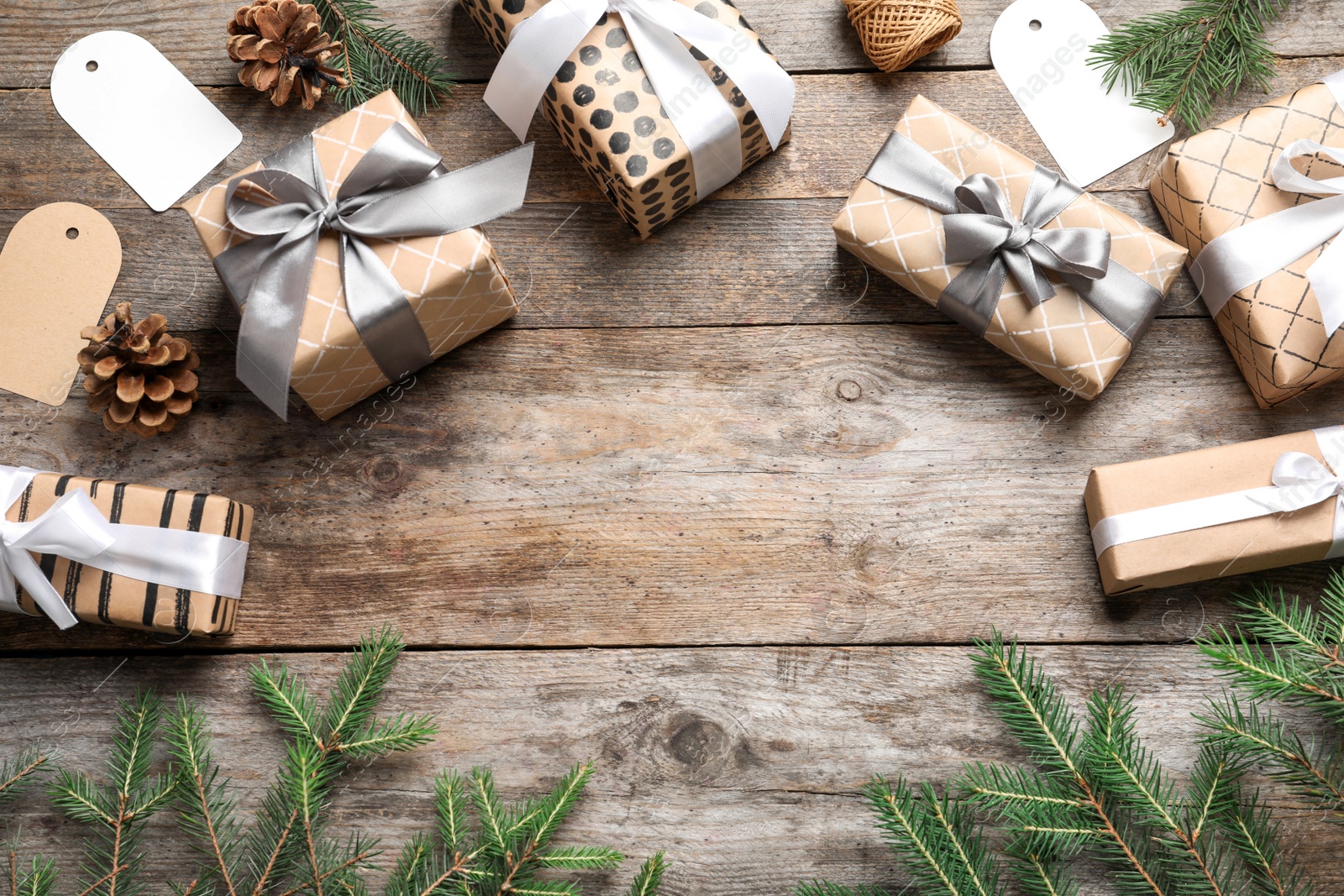 Photo of Flat lay composition with Christmas gifts and fir branches on wooden background