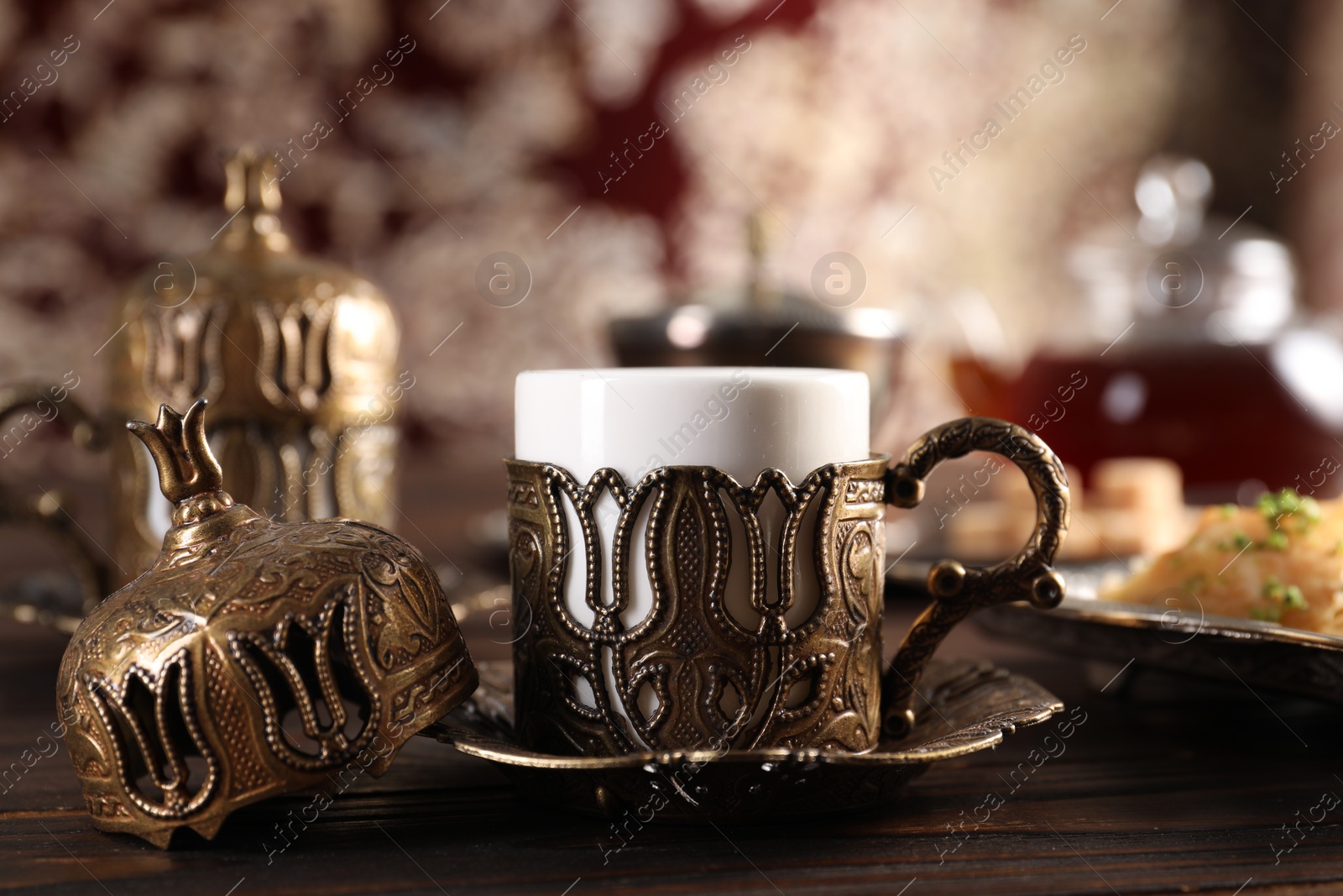 Photo of Traditional Turkish tea served in vintage tea set on wooden table