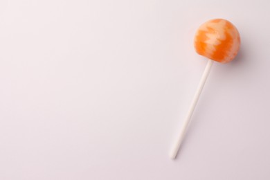 Photo of Tasty lollipop on white background, top view. Space for text