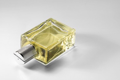 Luxury men`s perfume in bottle on white background, space for text