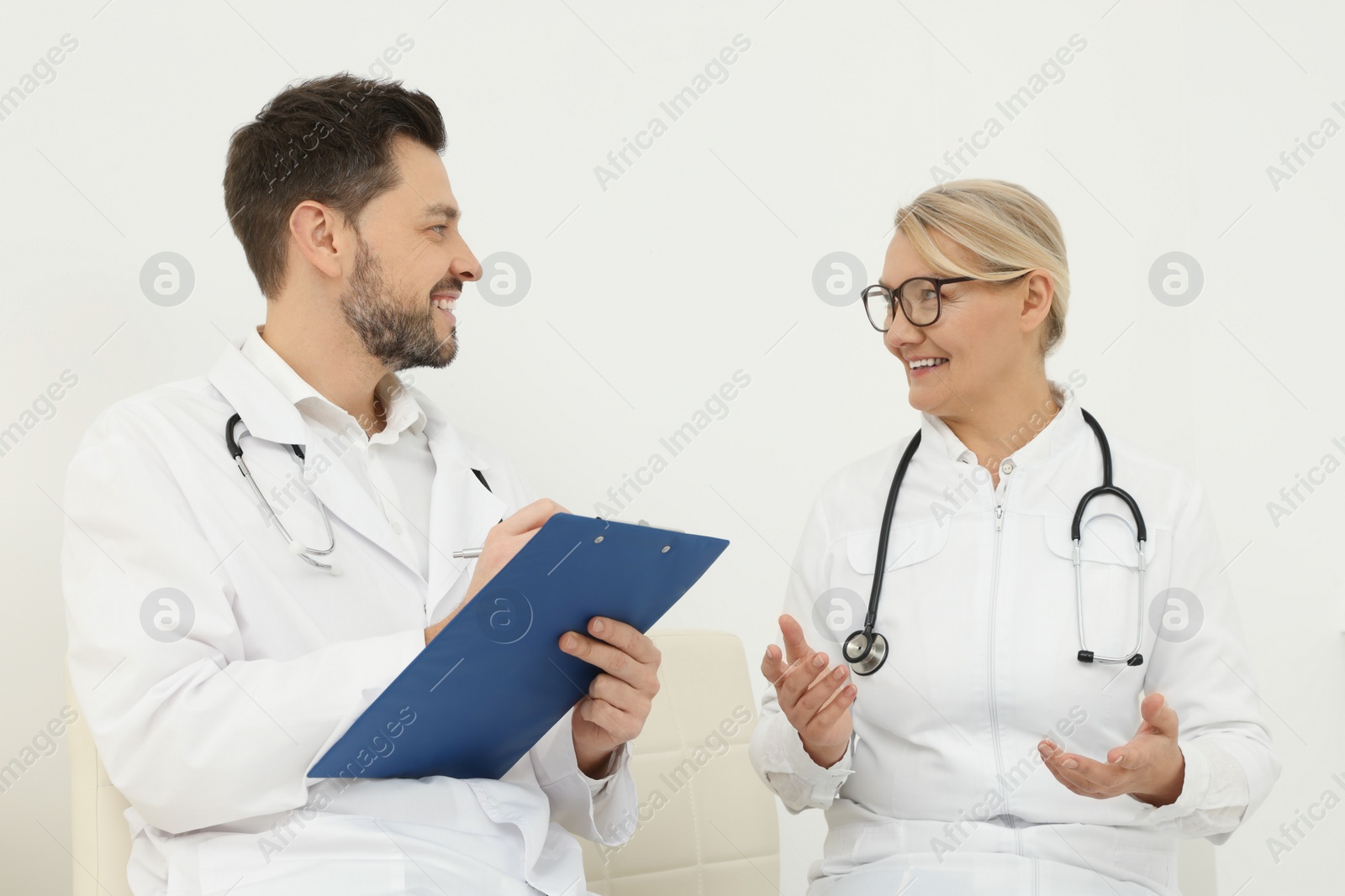 Photo of Professional doctors having discussion in office hall