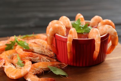 Photo of Delicious shrimp cocktail with tomato sauce served on table, closeup