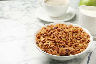Photo of Tasty healthy breakfast with muesli on marble table