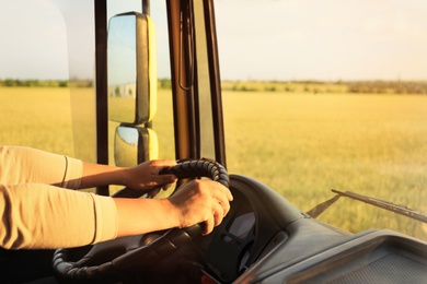 Man driving modern truck on sunny day, closeup