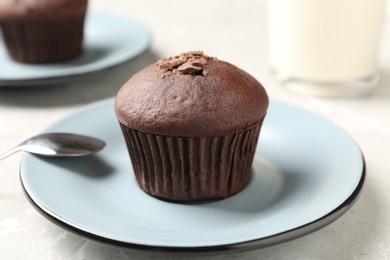 Photo of Delicious cupcake with chocolate crumbles on grey table, closeup