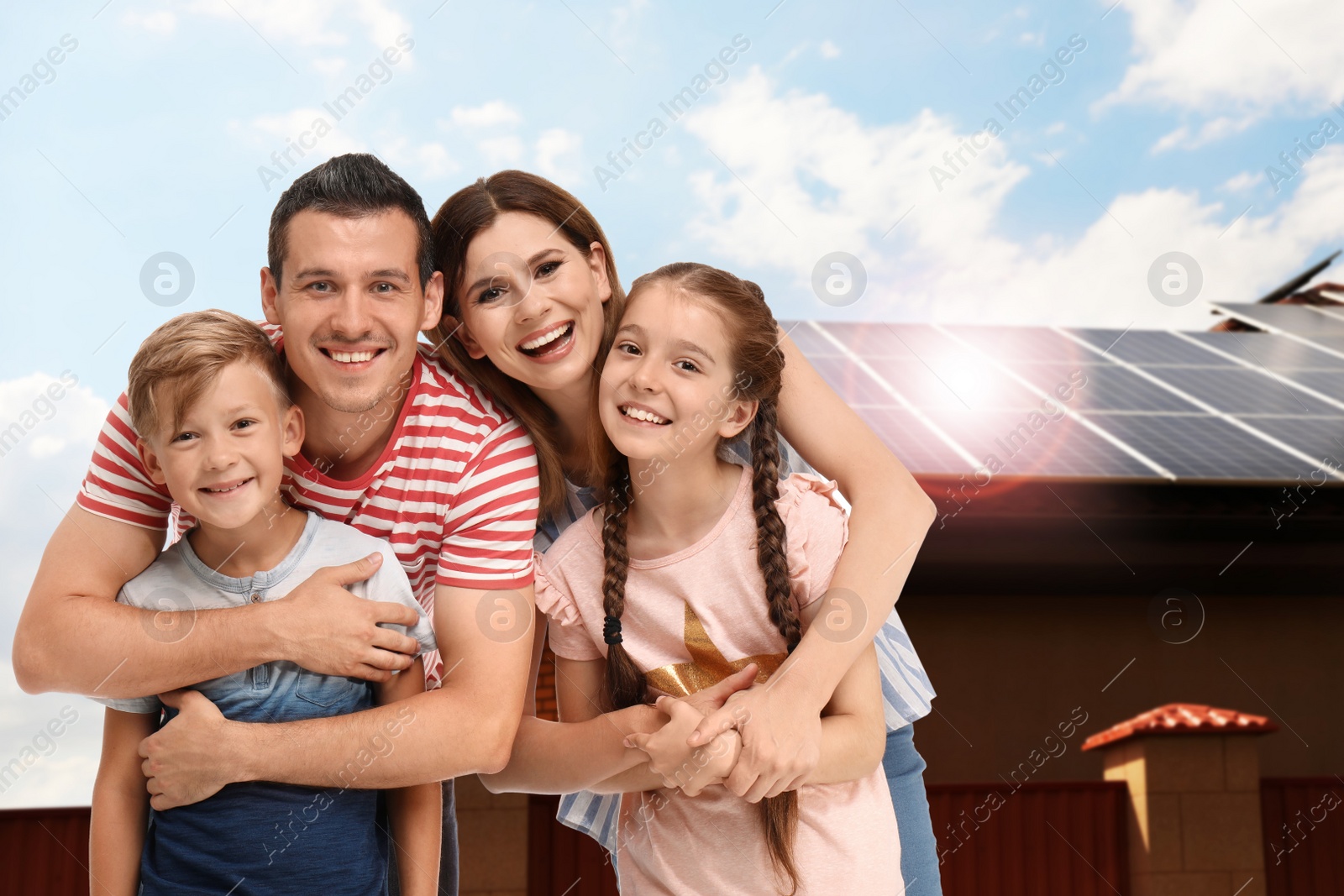 Image of Happy family near their house with solar panels. Alternative energy source