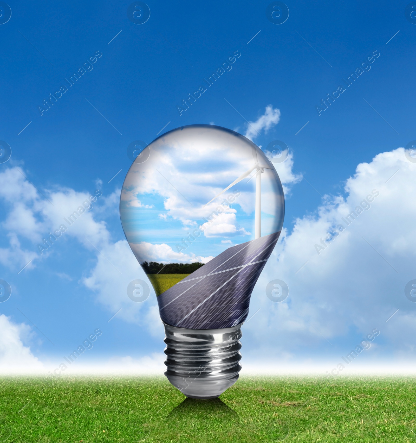 Image of Alternative energy source. Light bulb with solar panels and wind turbines outdoors