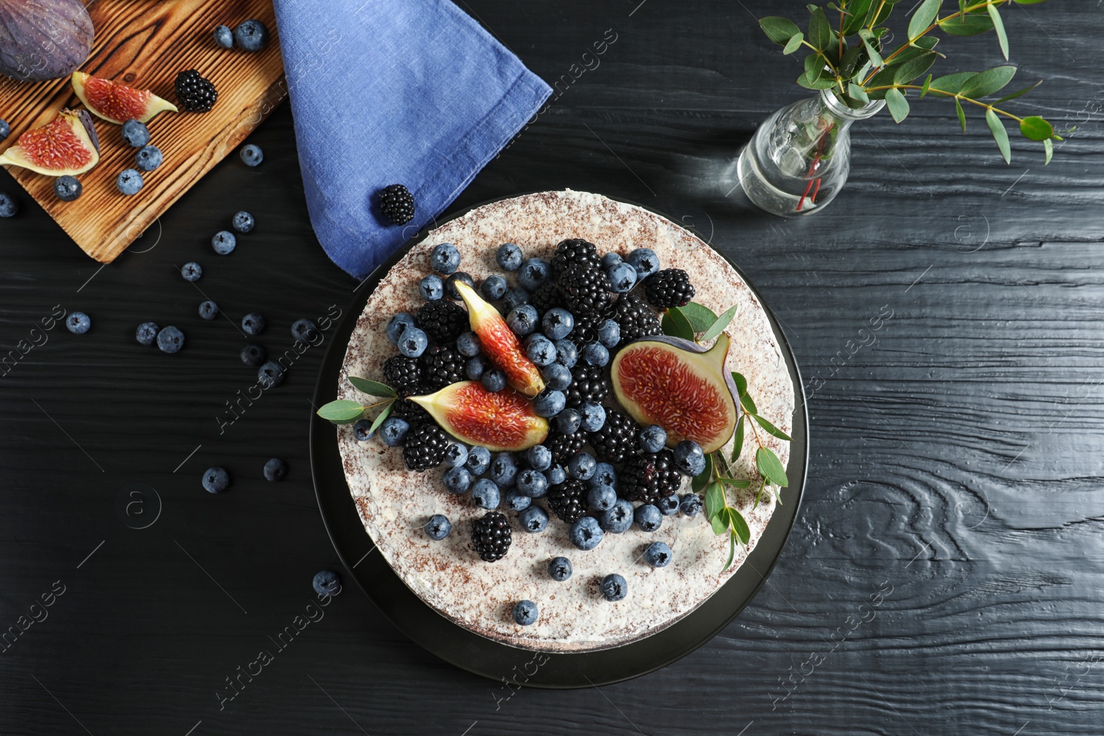 Photo of Delicious homemade cake with fresh berries served on dark wooden table, flat lay