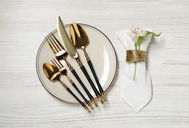 Photo of Stylish setting with elegant cutlery on white wooden table, top view