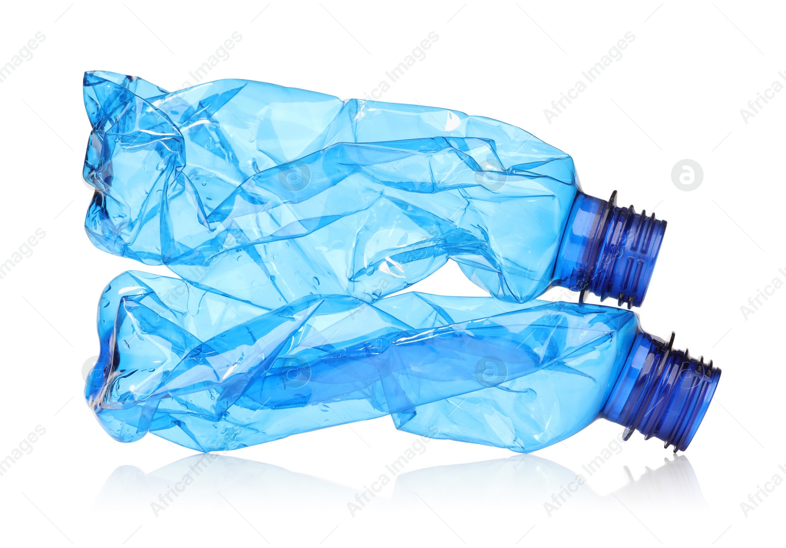 Photo of Crumpled disposable plastic bottles isolated on white