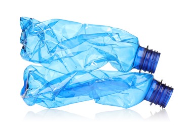 Photo of Crumpled disposable plastic bottles isolated on white