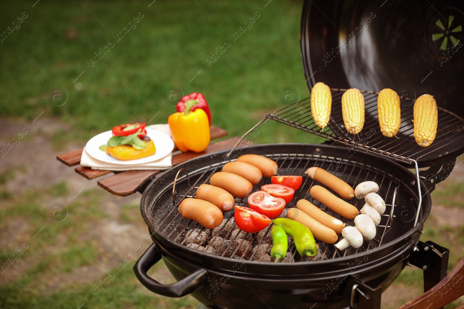 Photo of Barbecue grill with tasty fresh food outdoors