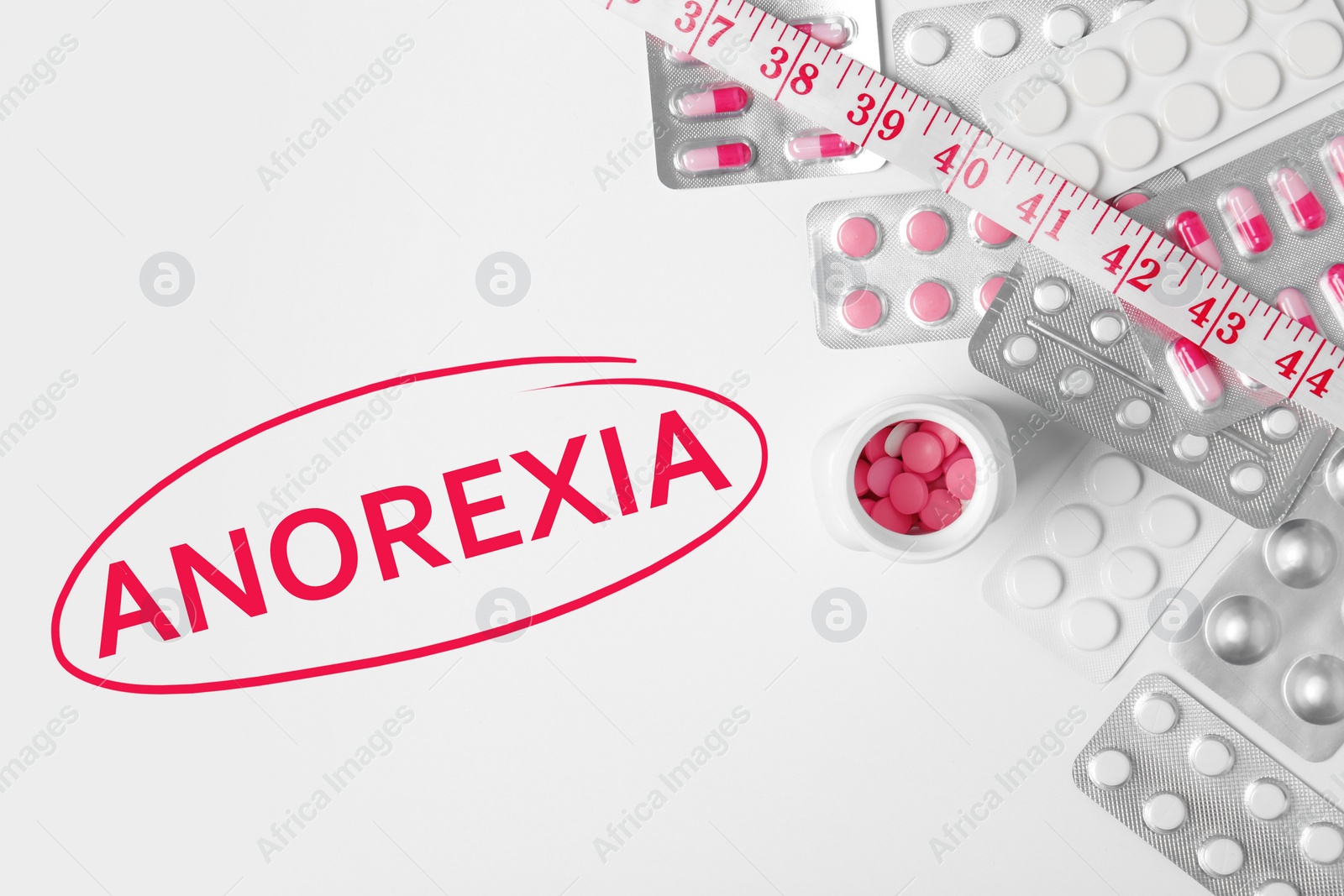 Image of Anorexia concept. Weight loss pills and measuring tape on white background, top view