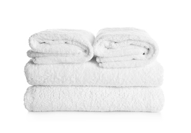 Stack of clean soft towels on white background