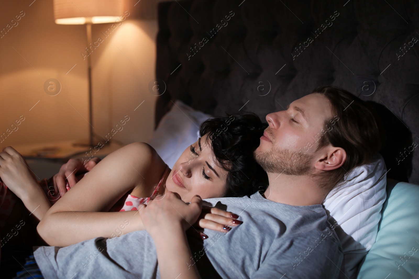 Photo of Young lovely couple sleeping in bed at home