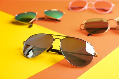 Photo of Stylish sunglasses on color background. Summer time
