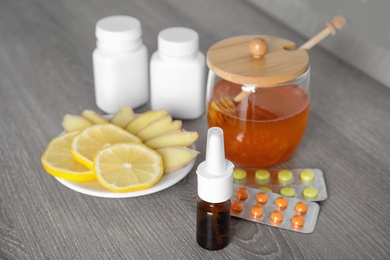 Photo of Nasal spray and different cold remedies on wooden table