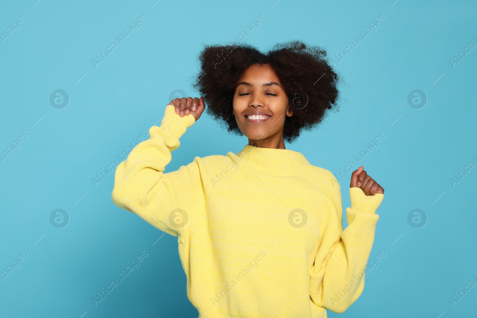 Photo of Portrait of smiling African American woman on light blue background