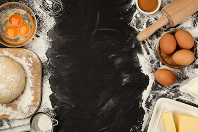 Photo of Flat lay composition with eggs and other ingredients on black table, space for text. Baking pie