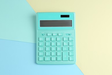 Modern calculator on color background, top view