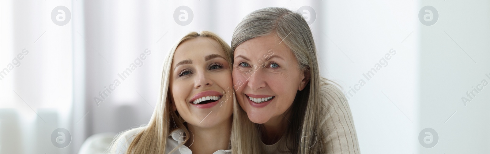 Image of Happy mother and daughter indoors, banner design