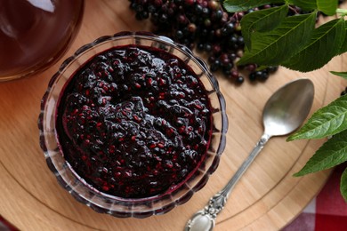 Photo of Elderberry jam with Sambucus berries on table, flat lay