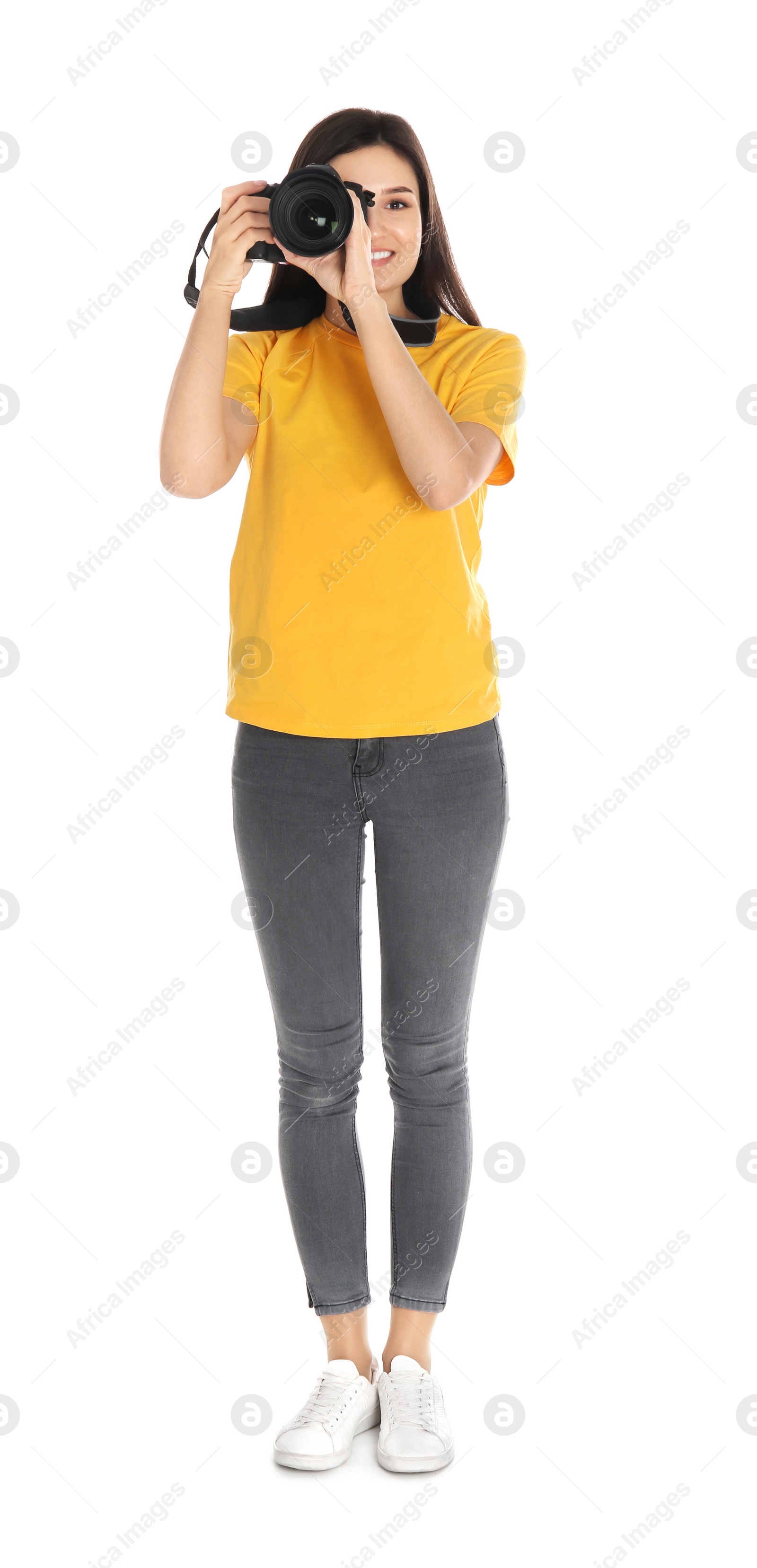 Photo of Young female photographer with camera on white background