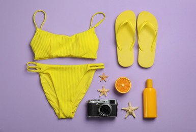 Flat lay composition with beach objects on violet background