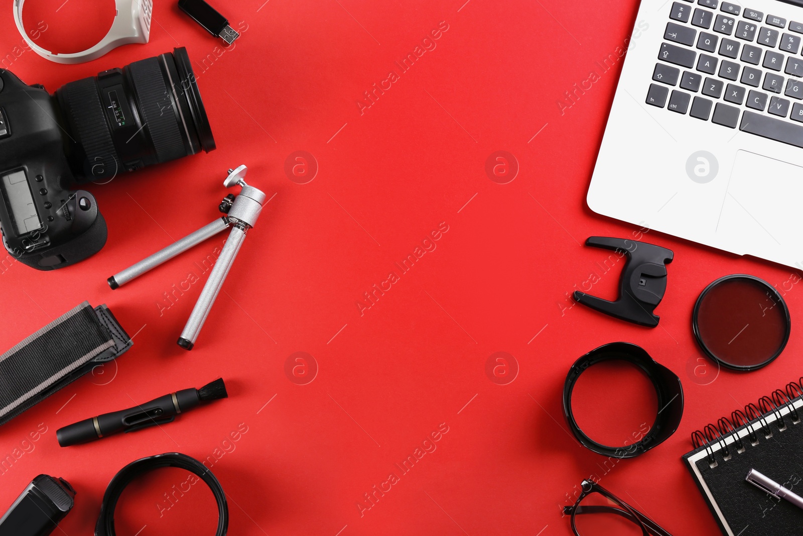 Photo of Flat lay composition with camera and video production equipment on red background. Space for text