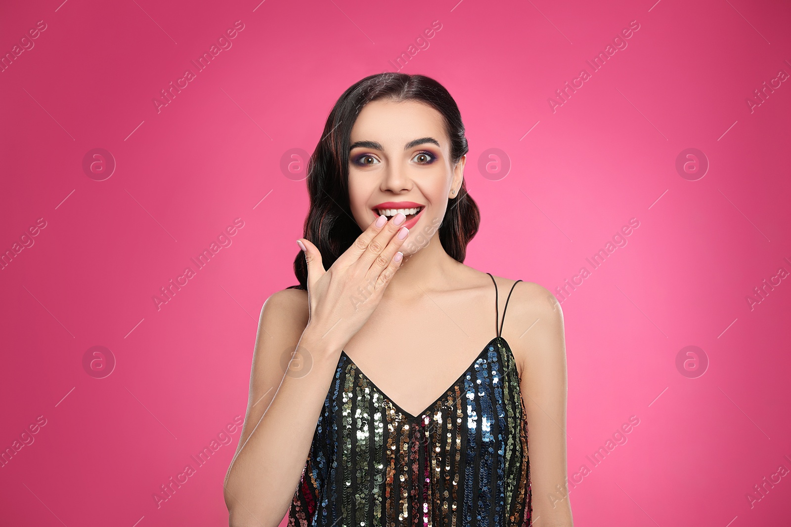 Photo of Portrait of surprised woman on pink background