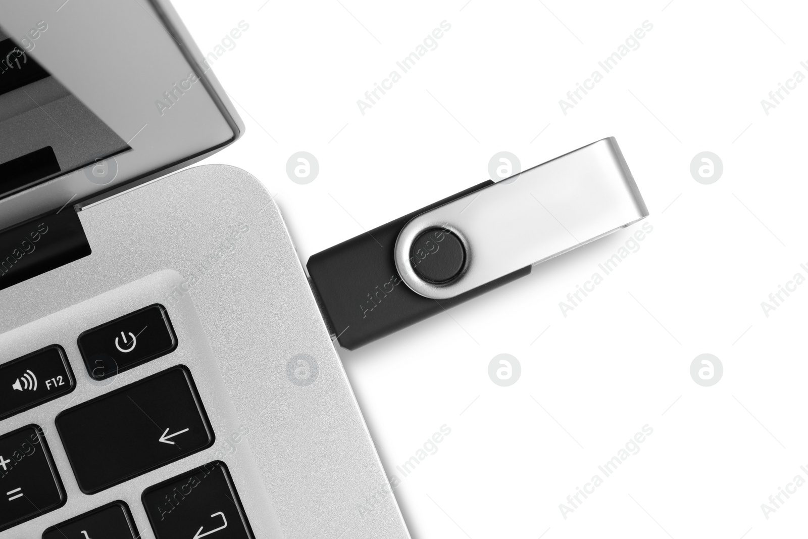 Photo of Modern usb flash drive attached into laptop on white background, top view