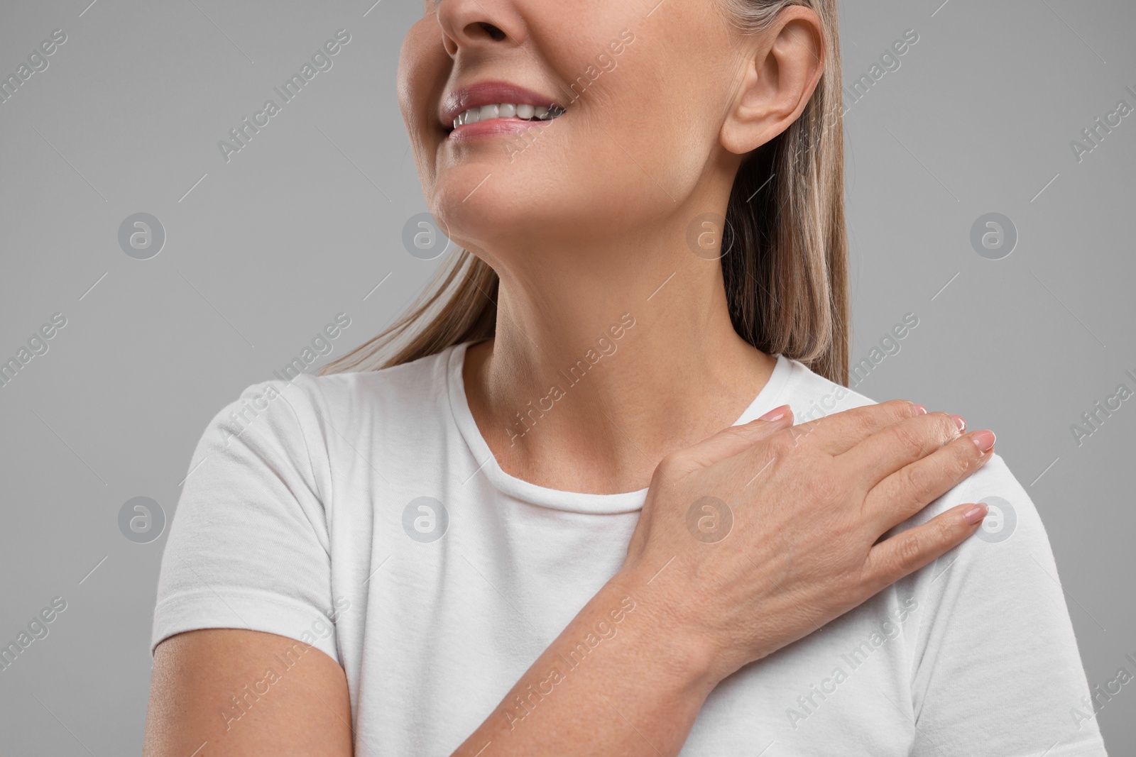 Photo of Mature woman with healthy skin on grey background, closeup