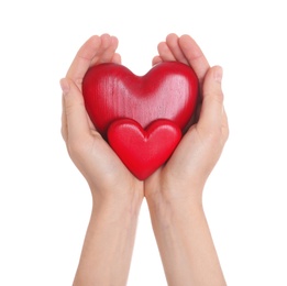 Woman holding decorative hearts in hands on white background, closeup