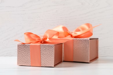 Photo of Beautiful gift boxes with bows on white table