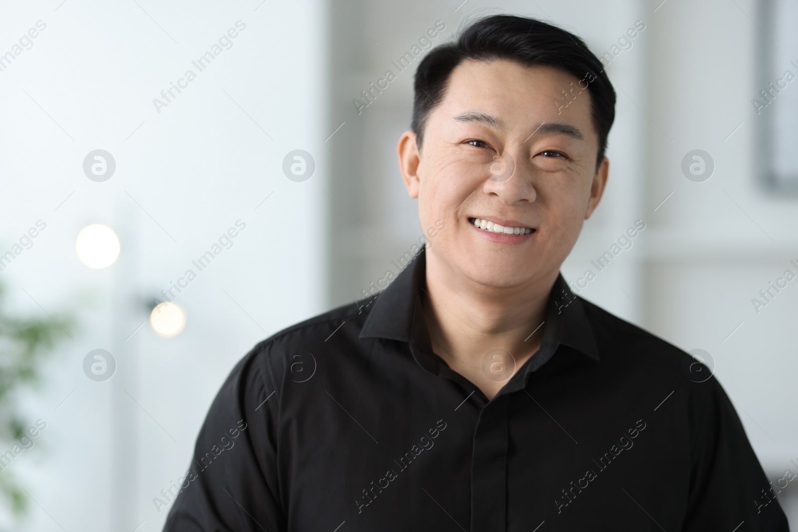 Photo of Portrait of smiling businessman in office. Space for text