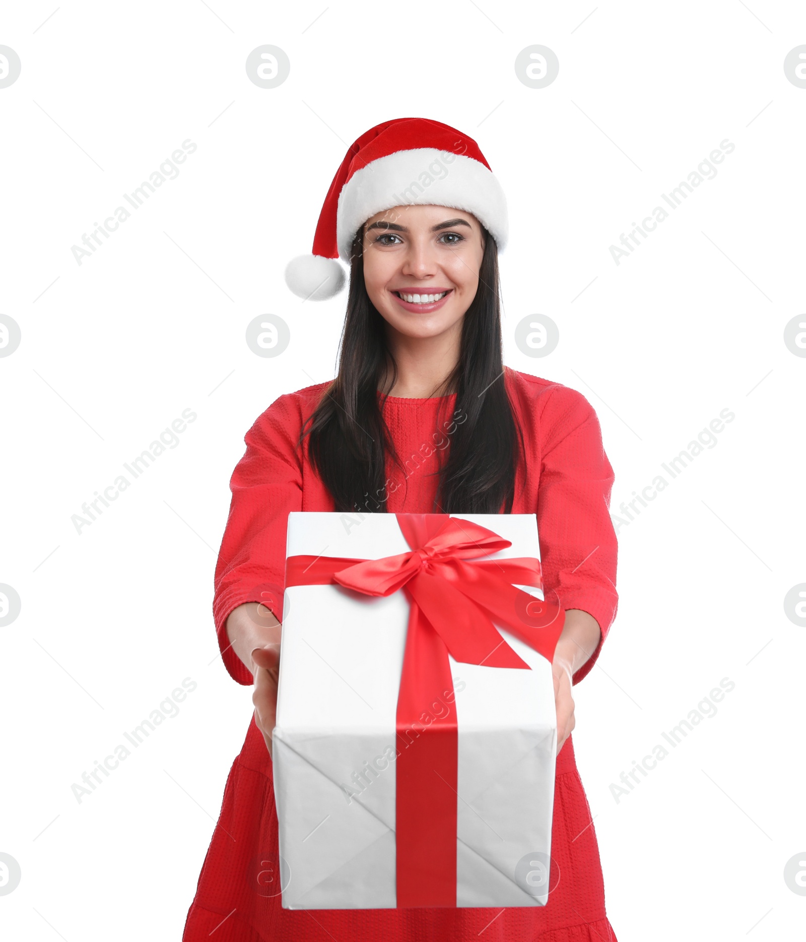 Photo of Happy young woman in Santa hat holding Christmas gift on white background