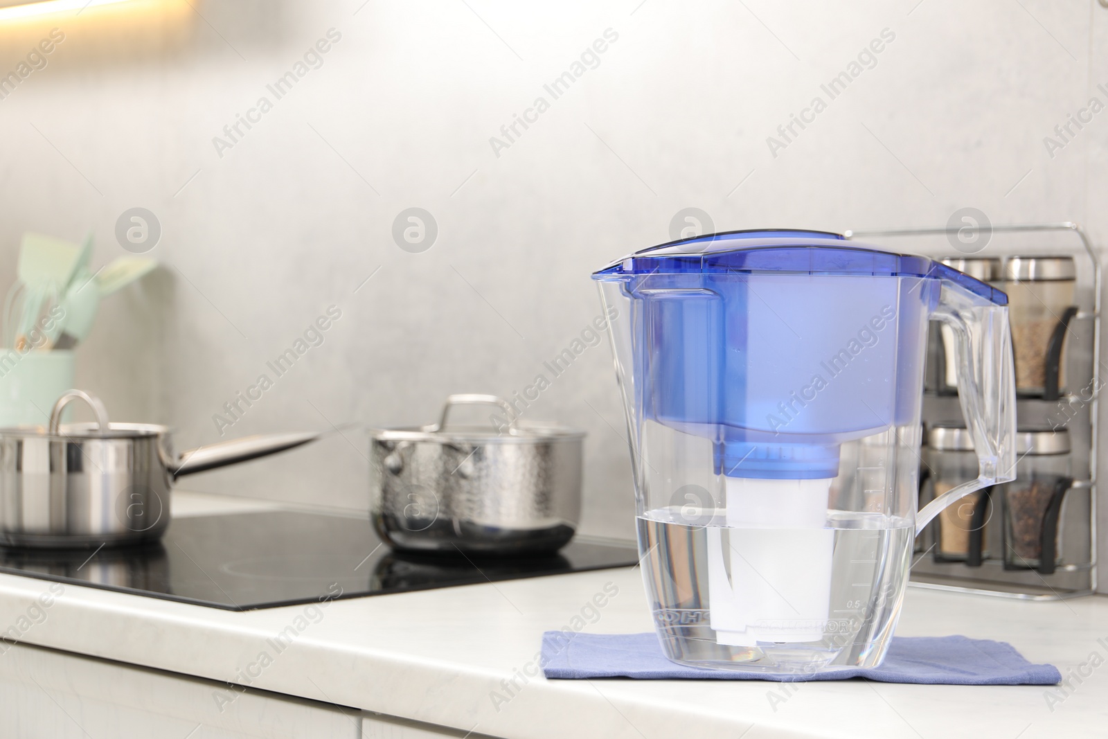 Photo of Water filter jug on white countertop in kitchen